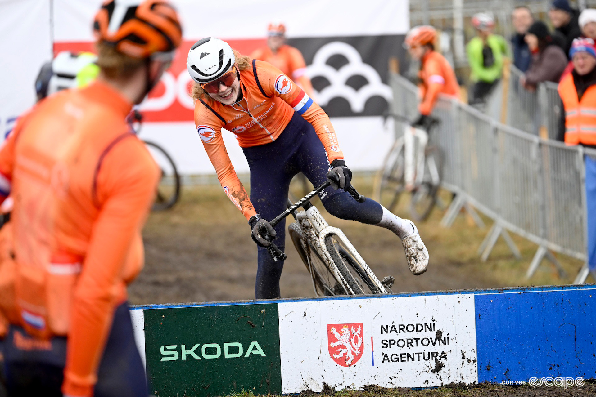 Puck Pieterse pictured laughing with her teammates in the orange Dutch national kit during a recon ride before the 2024 UCI Cyclo-Cross World Championships in Tábor.