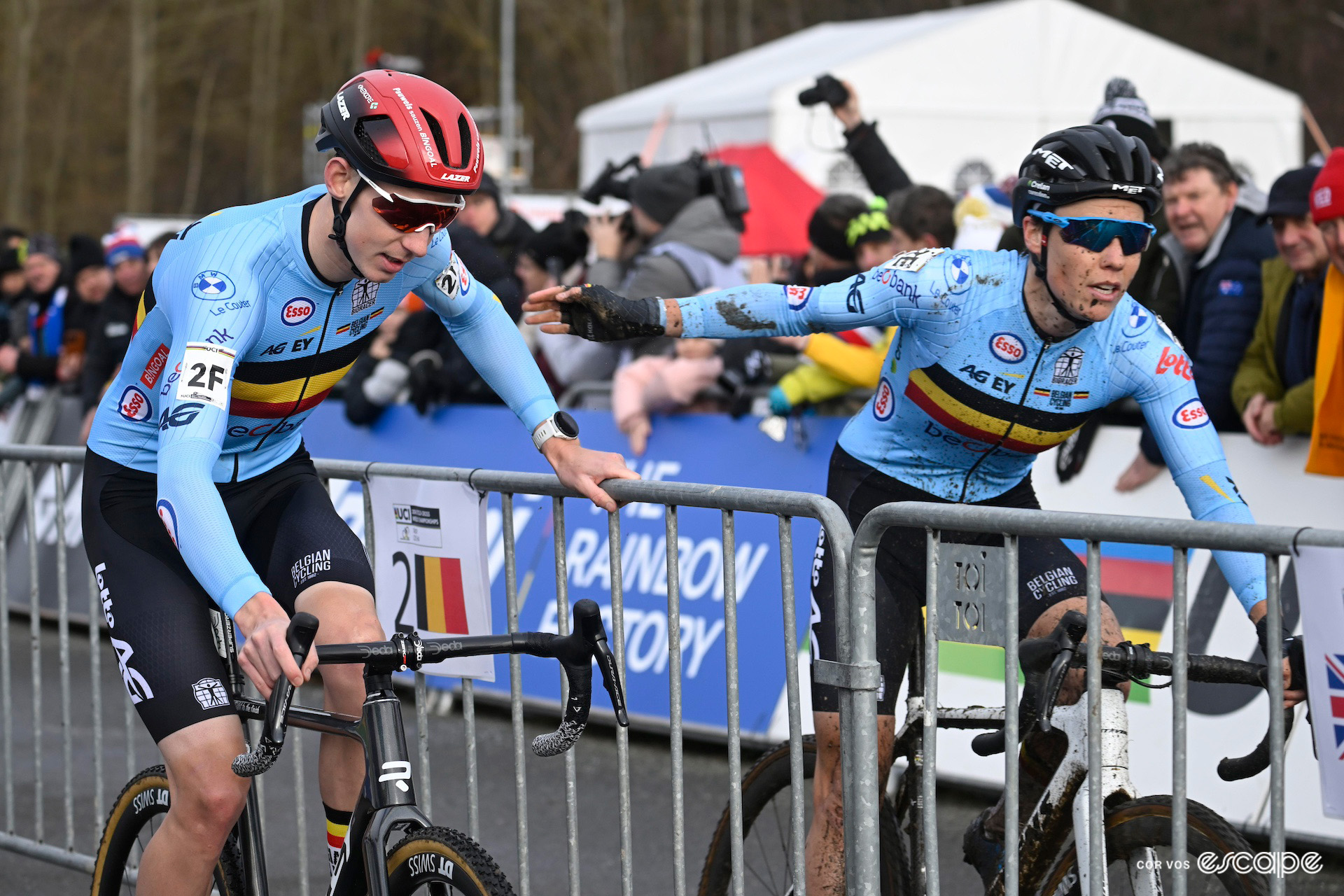 Belgian riders Michael Vanthourenhout and Sanne Cant execute a handover during the team relay at the 2024 UCI Cyclo-Cross World Championships in Tábor.