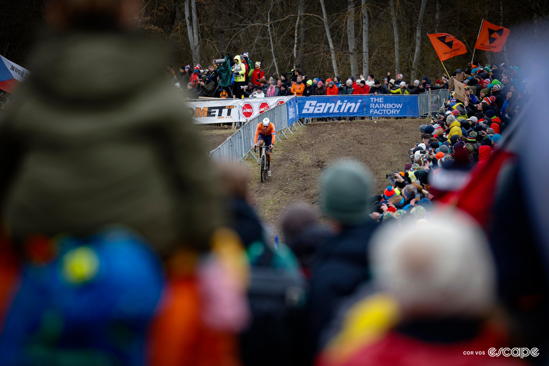 A wide shot of Mathieu van der Poel in the orange kit of the Netherlands during the 2024 Cyclocross World Championships in Tábor.