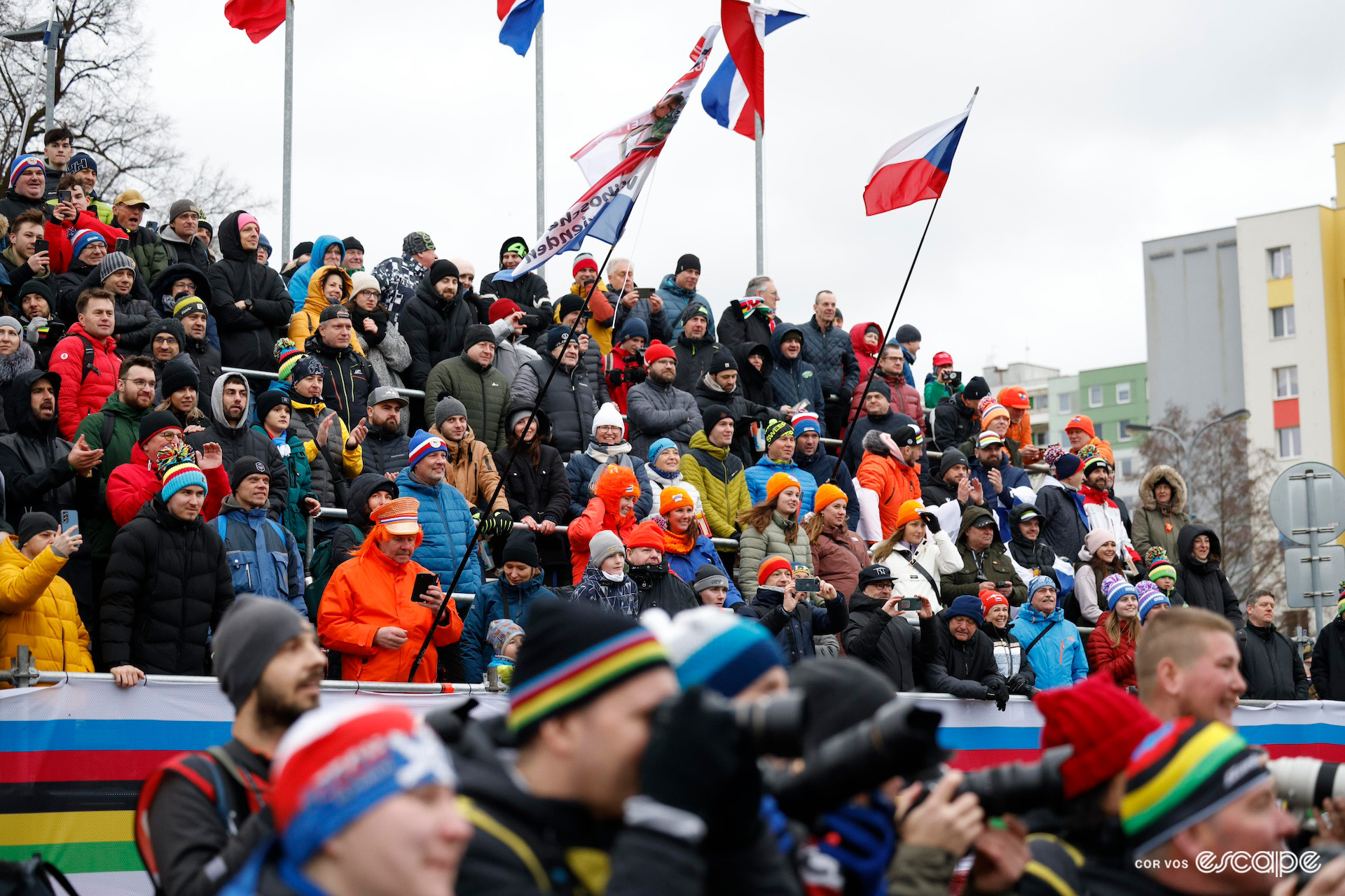 The crowd in the tiered seating that faces the podium as the elite men's race is celebrated at the 2024 Cyclocross World Championships in Tábor.