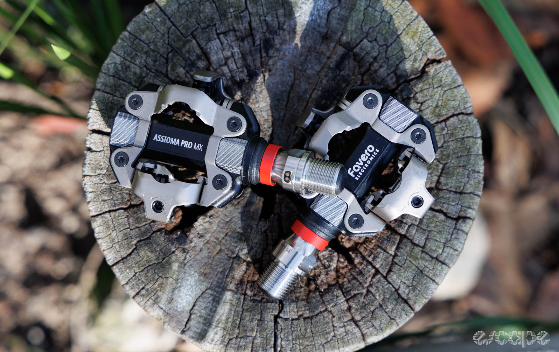 A pair of Favero Assioma Pro MX-2 pedals on a stump. 