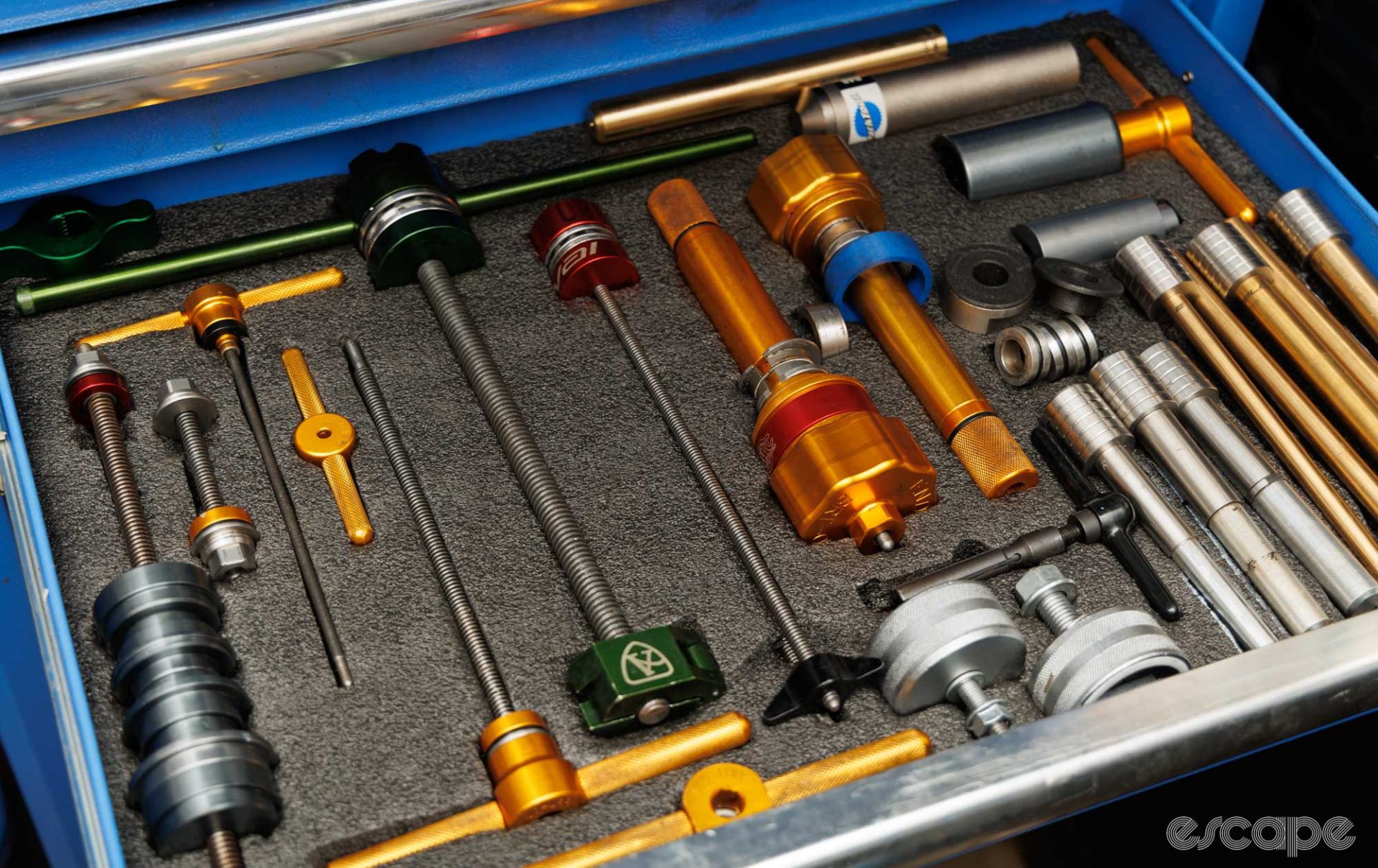 A drawer full of bearing-related tools, all neatly stored within a foam lining. 