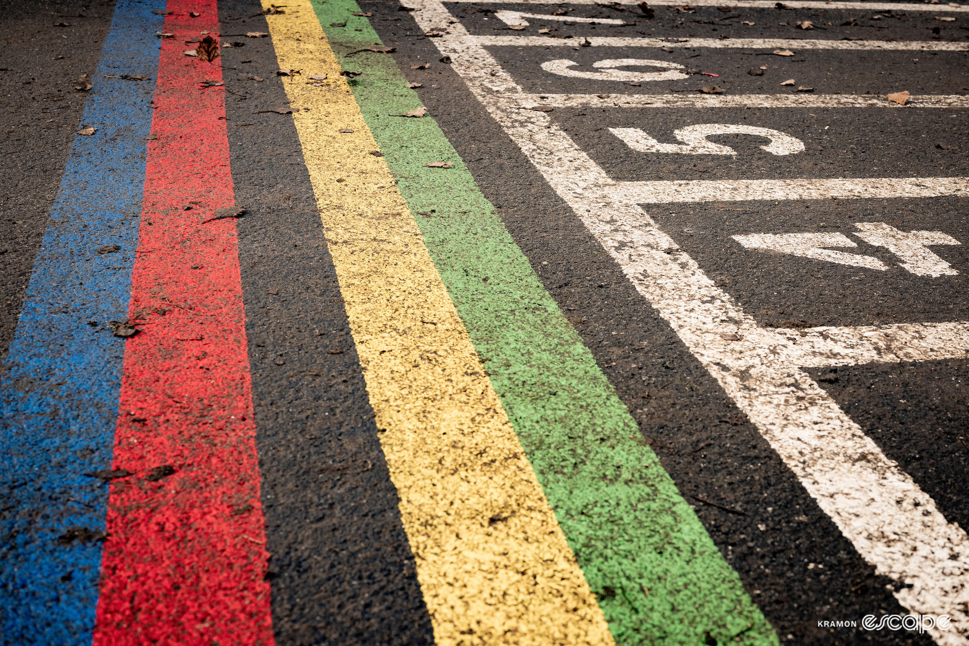 A detail shot of the rainbow-painted start line at the 2024 Cyclocross World Championships in Tábor.