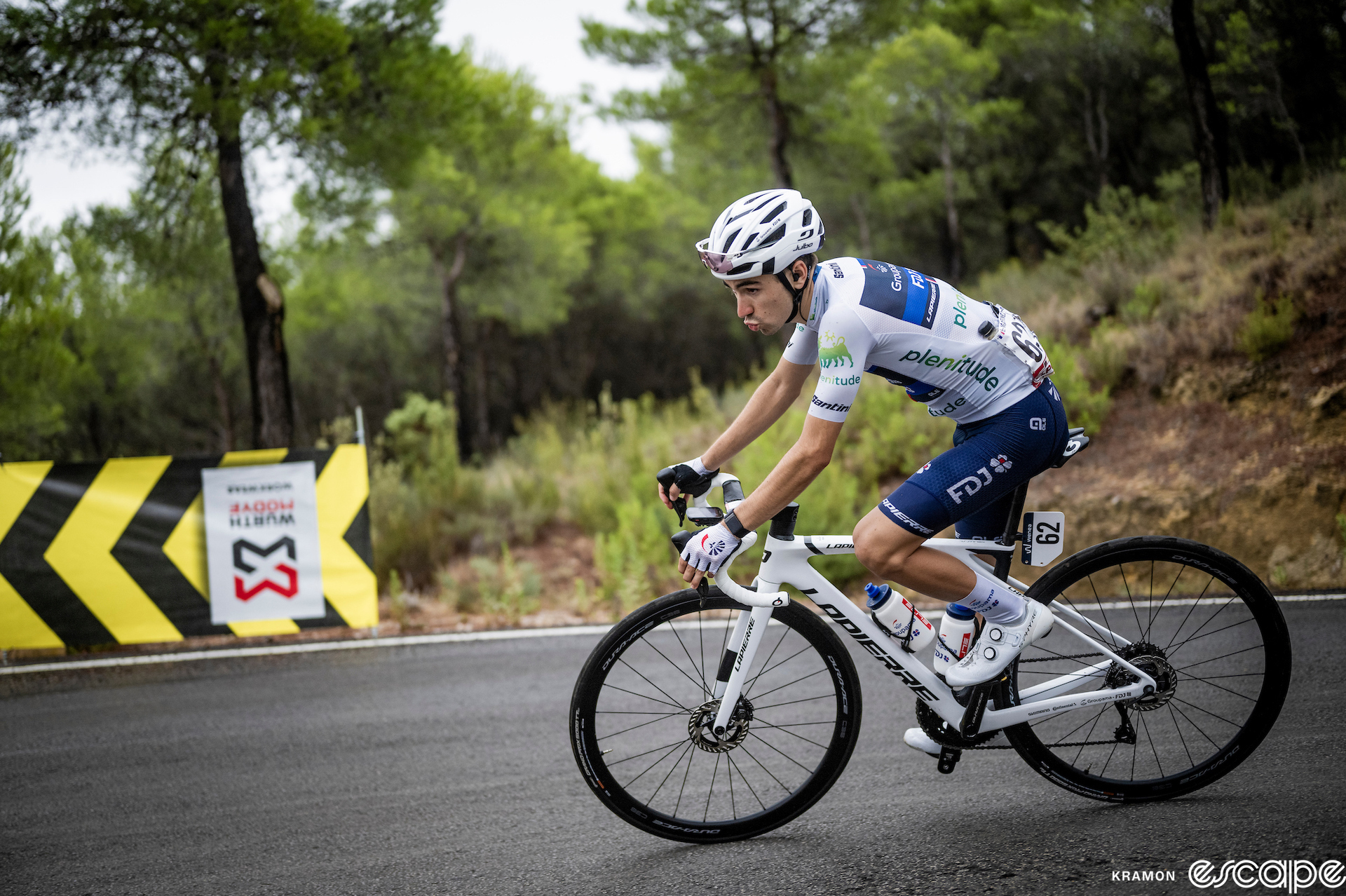 Lenny Martinez rides a climb at the 2023 Vuelta España. He's wearing the white jersey of the race's best young rider.