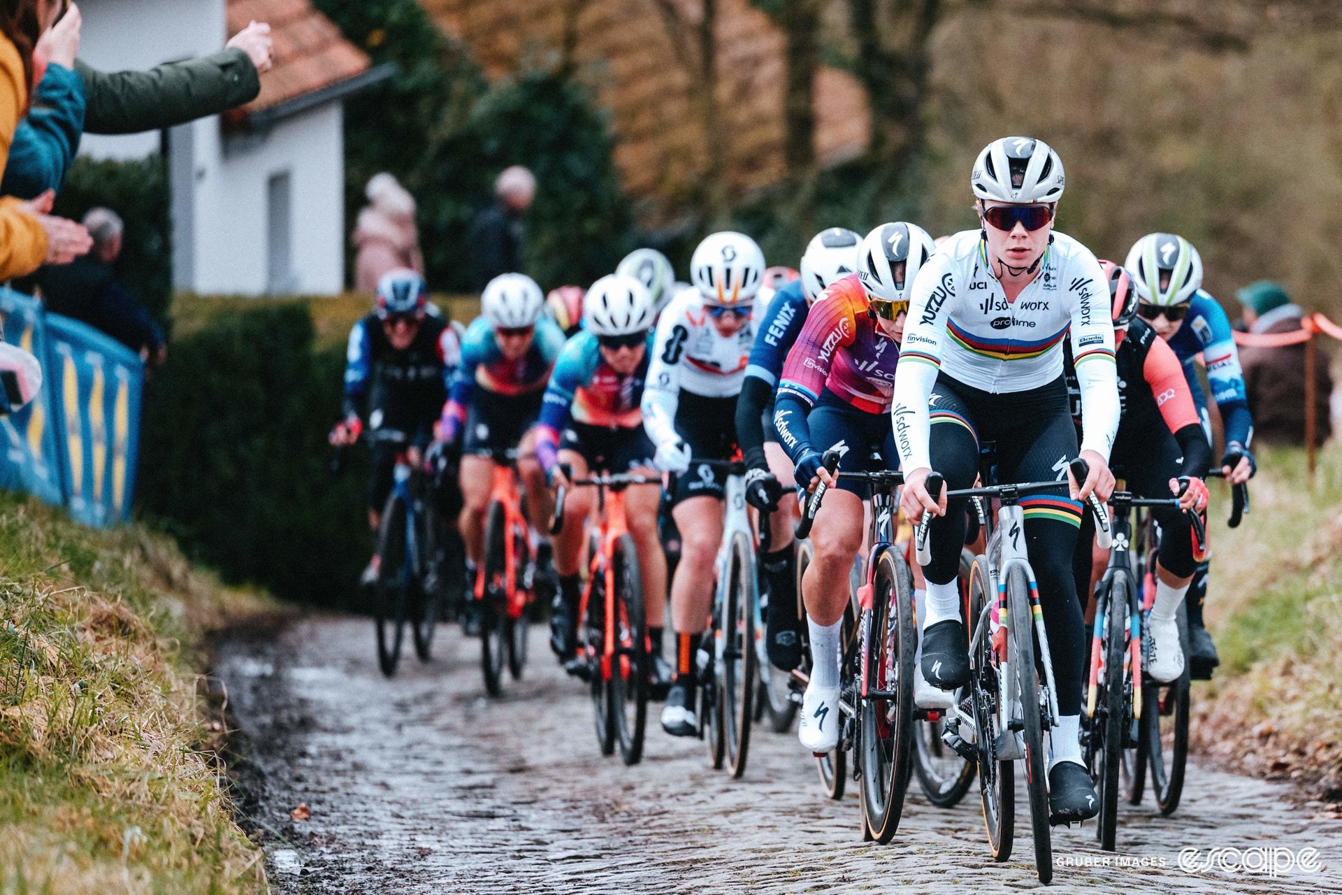 Lotte Kopecky leads the bunch up a cobbled climb.