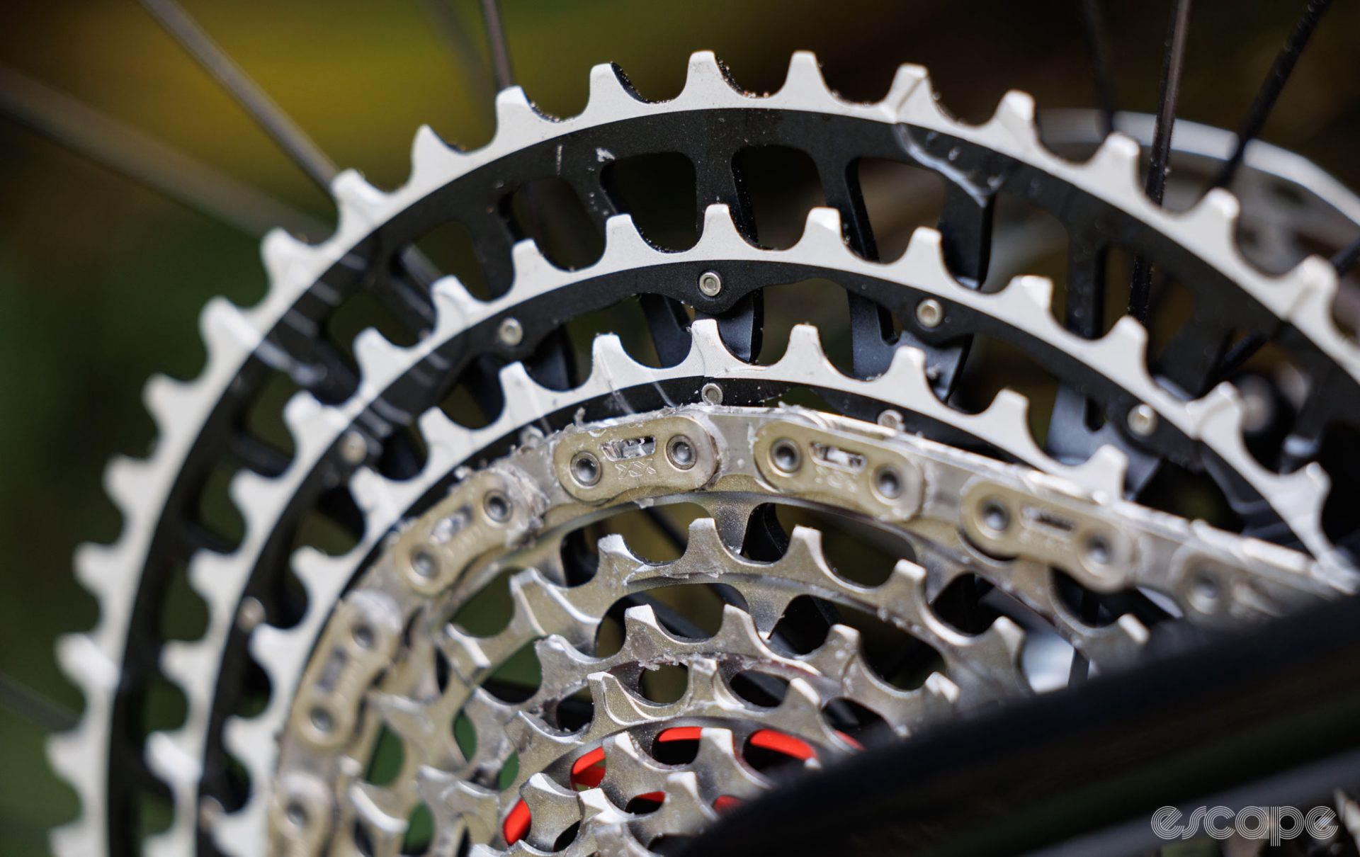 A close-up of a SRAM XX SL chain on a cassette, treated with wax. 