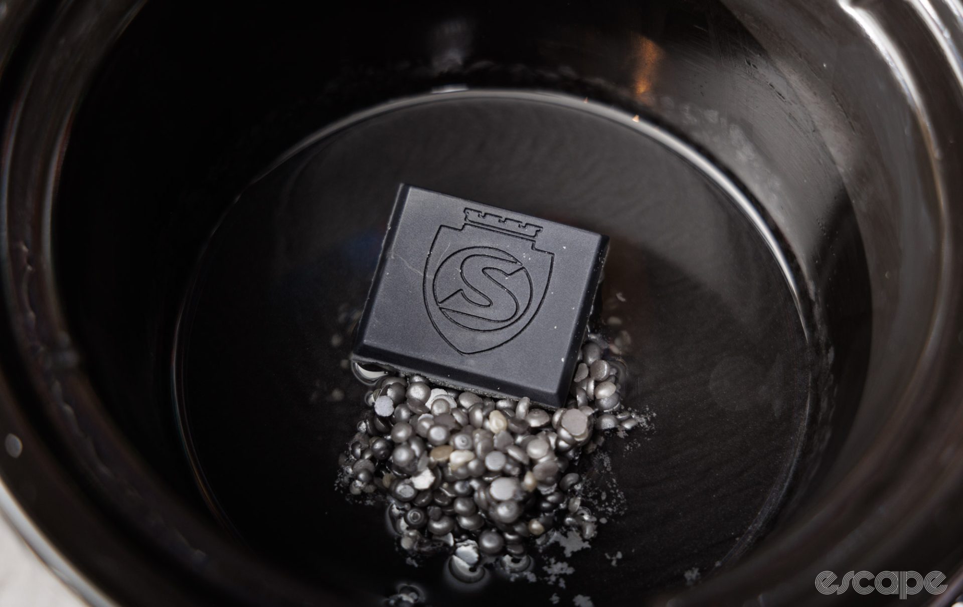 A Silca StripChip block sits in a crockpot, slowly melting on a bed of wax pellets. 