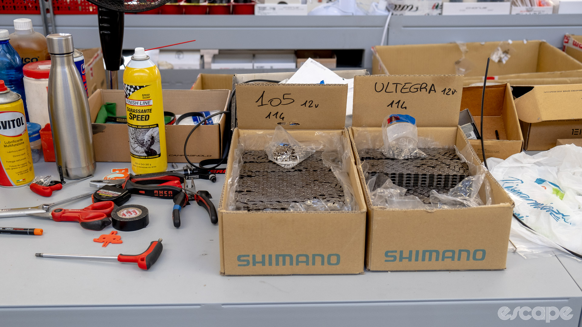 The photo shows two boxes of Shimano chains, one with Ultegra chains and one with 105 chains.
