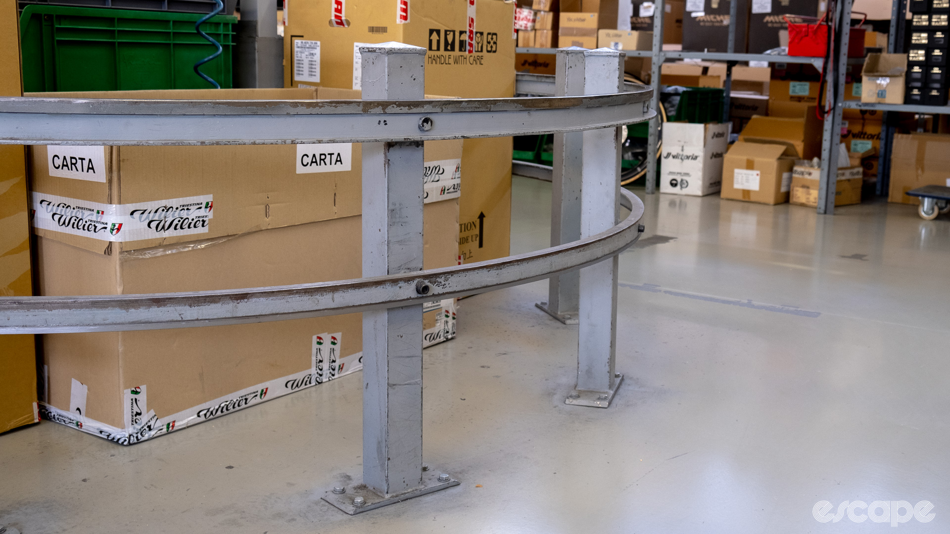 The photos show the rails the bike stands roll on cornering around the end of the assembly line to take the bikes up the opposite side. 