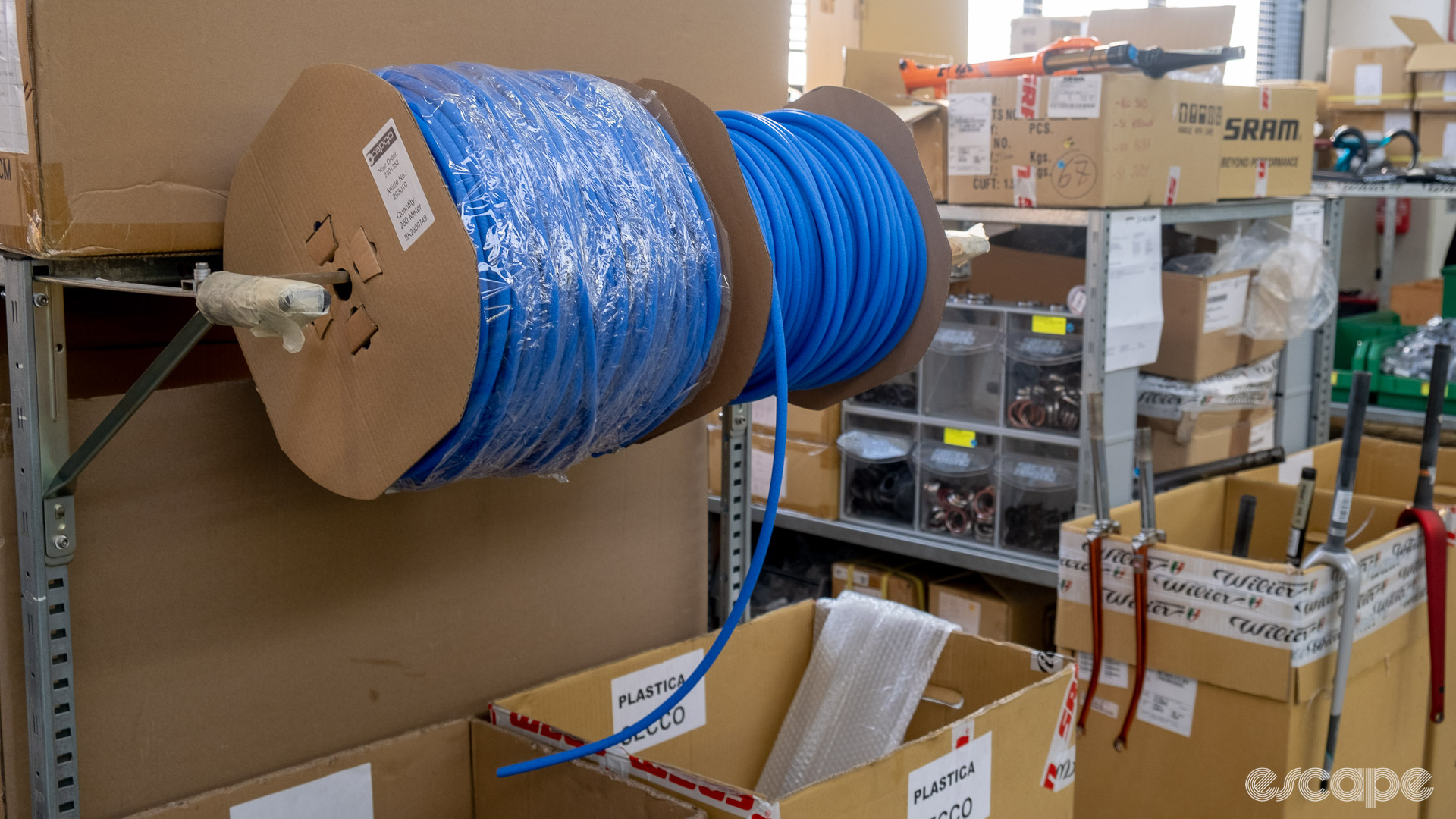 The photo shows rolls of blue foam liners at Wilier's assembly line 