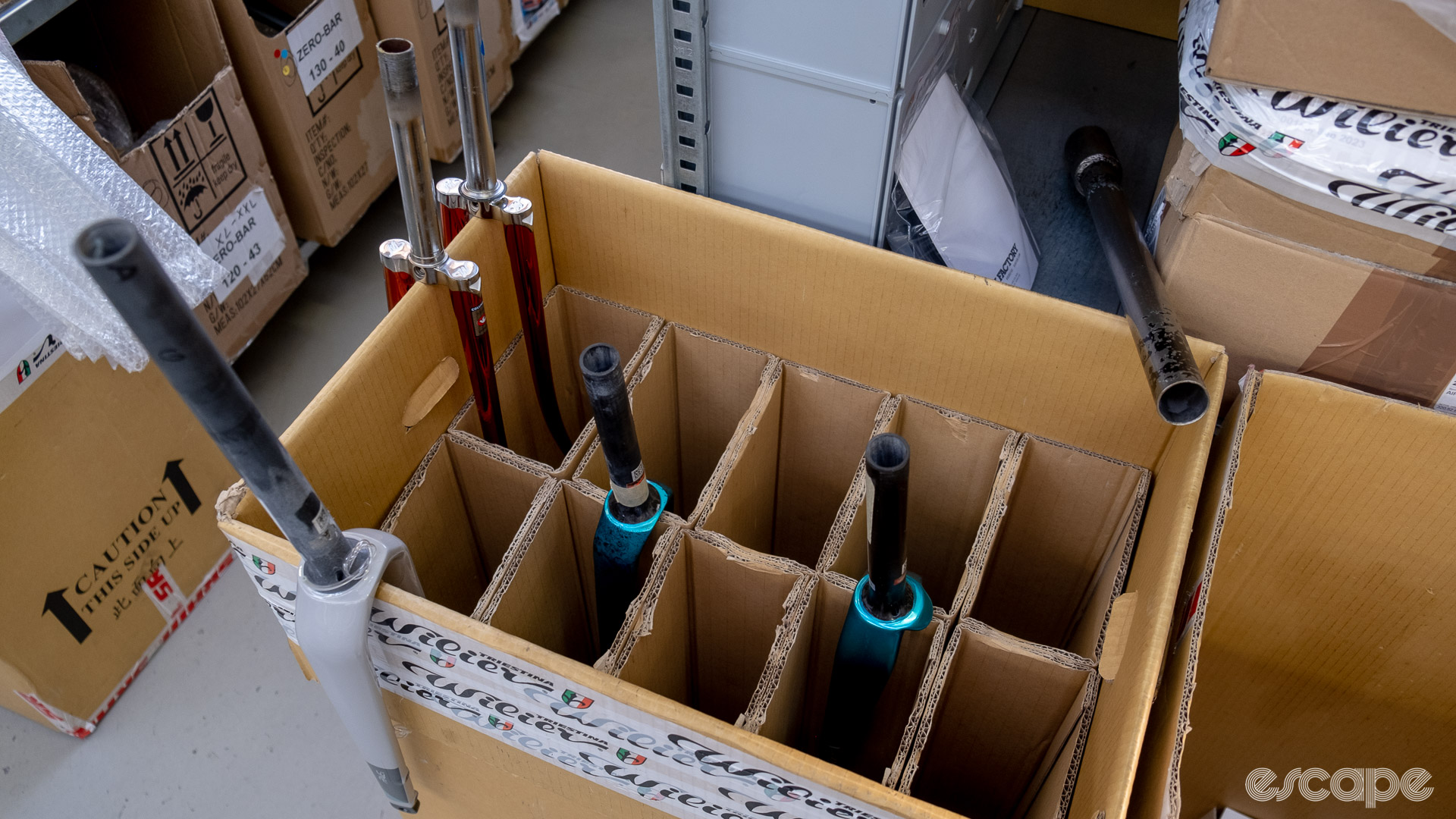 The photo shows a box with some new forks at the side of the assembly line.