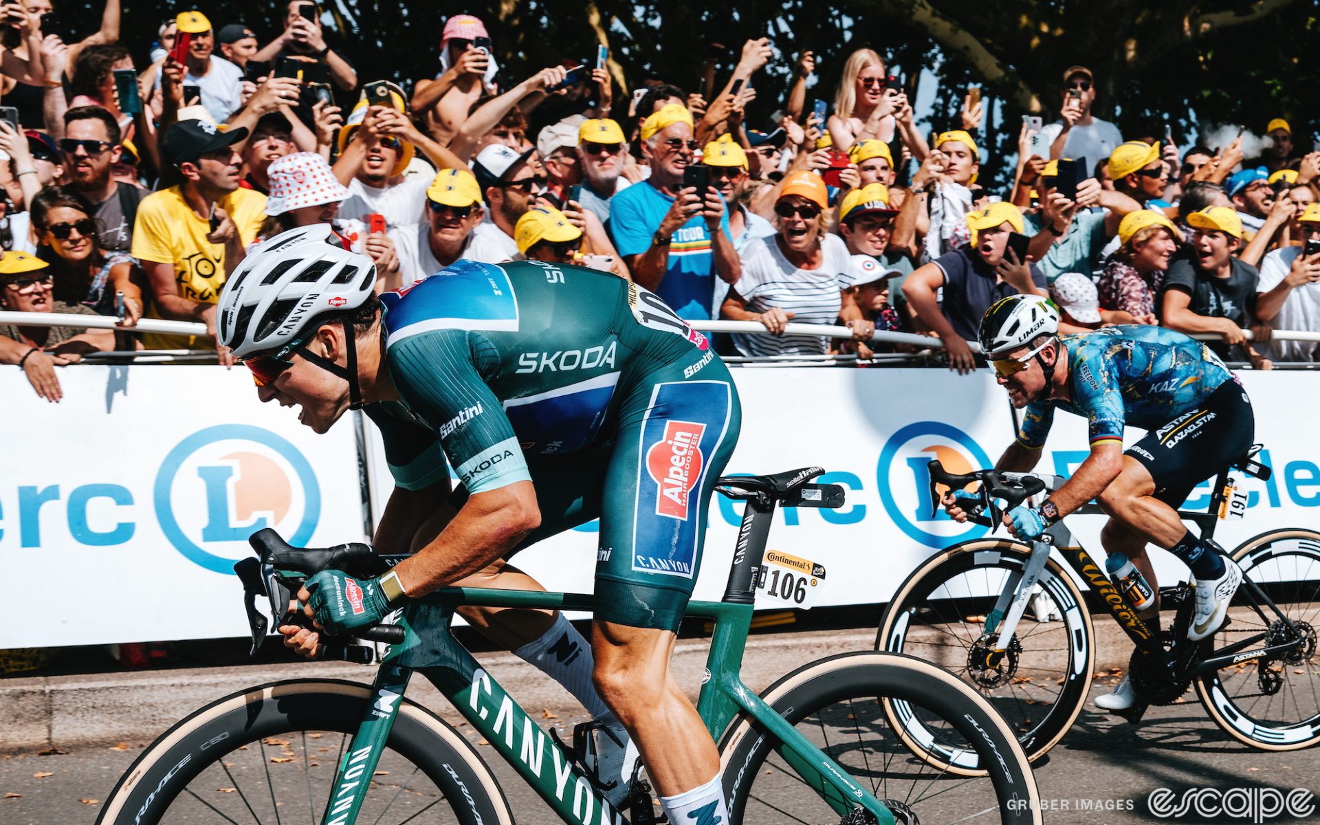 Jasper Philipsen, now wearing the green jersey of best sprinter, dashes to the line in stage 7 of the Tour. He's aboard a matching green Canyon and behind and to his right is Mark Cavendish, who will finish second, just denied in his quest for a record-breaking 35th Tour stage win.