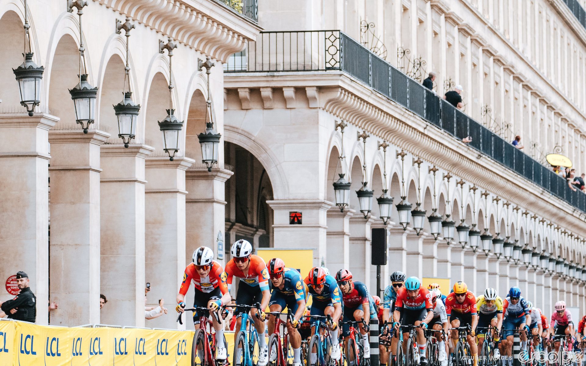 The Lidl-Trek team rides at the front of the pack in the Tour de France. Multiple riders are on the front in a train and the pack is strung out behind.