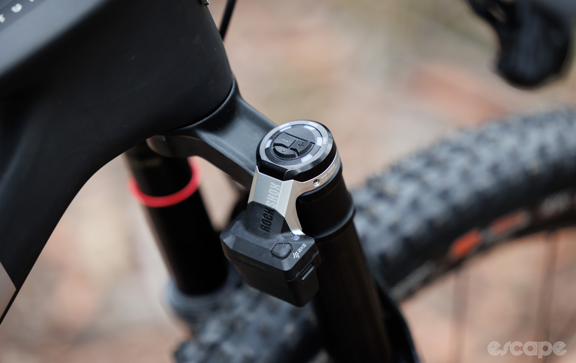 Close up of the RockShox SID Flight Attendant control unit on the fork. 