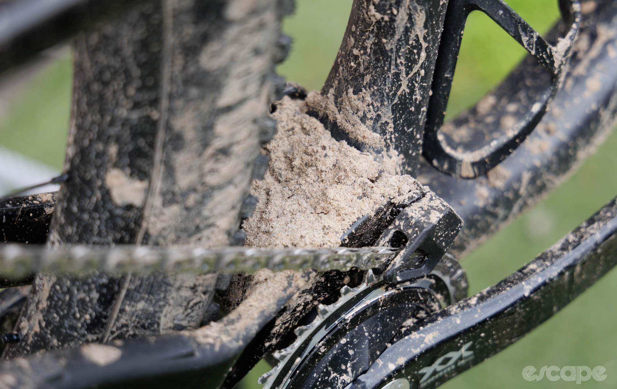 The rear frame with the main pivot covered in a pile of grit. 