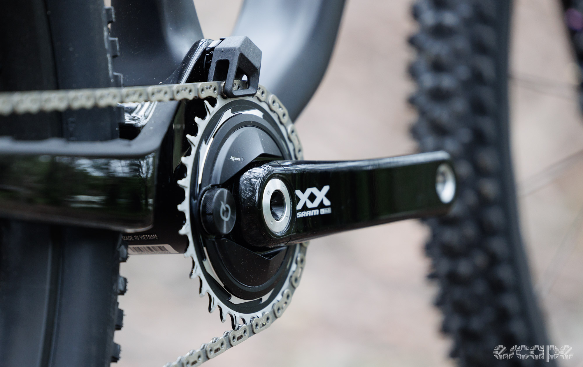 A close up of the SRAM XX SL crankset and integrated chain guide. 