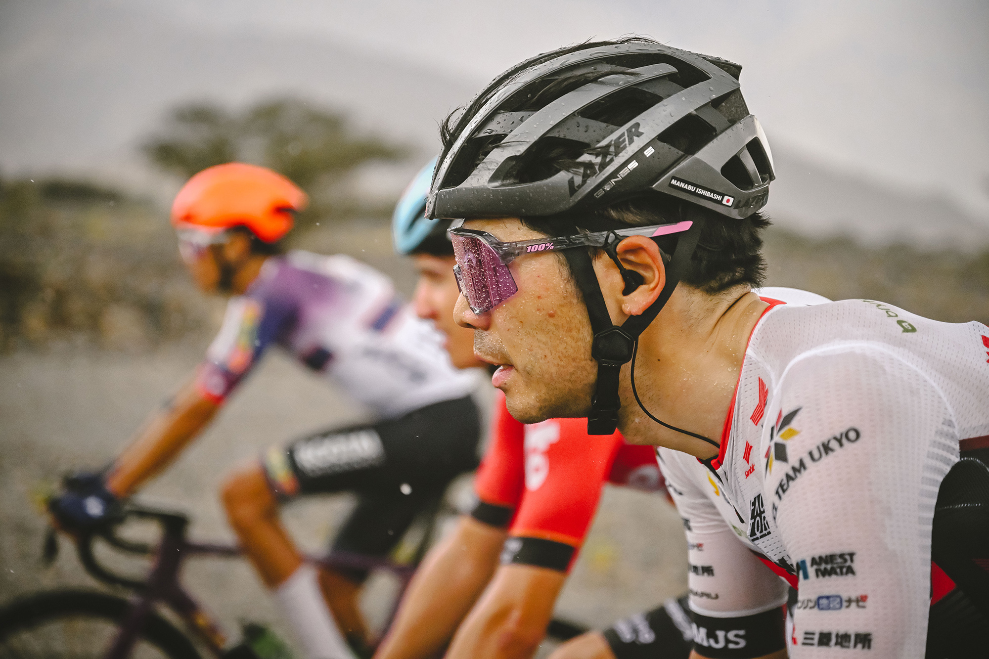 A close up of a Manabu Ishibashi in the rain at the Tour of Oman.