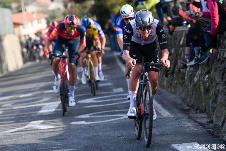 Tadej Pogačar launches an attack on the Poggio at the 2023 Milan-San Remo. Behind, riders like Filippo Ganna and Wout van Aert struggle to close the gap.