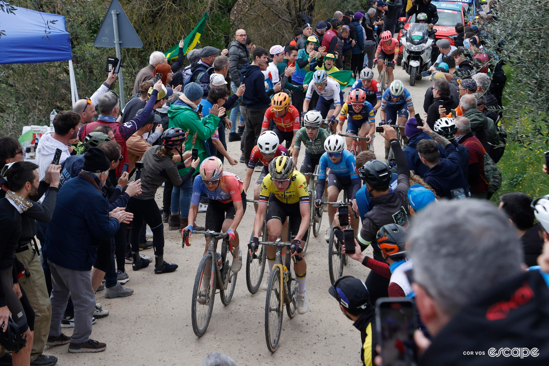 The breakaway climbs a cobbled sector through crowds during the 2024 women's Strade Bianche.