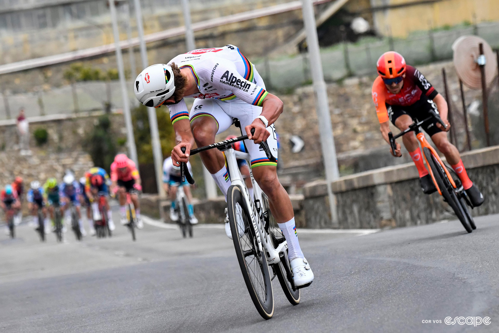 Mathieu van der Poel looks around at the chasers on the descent off the Poggio during Milan-San Remo 2024.