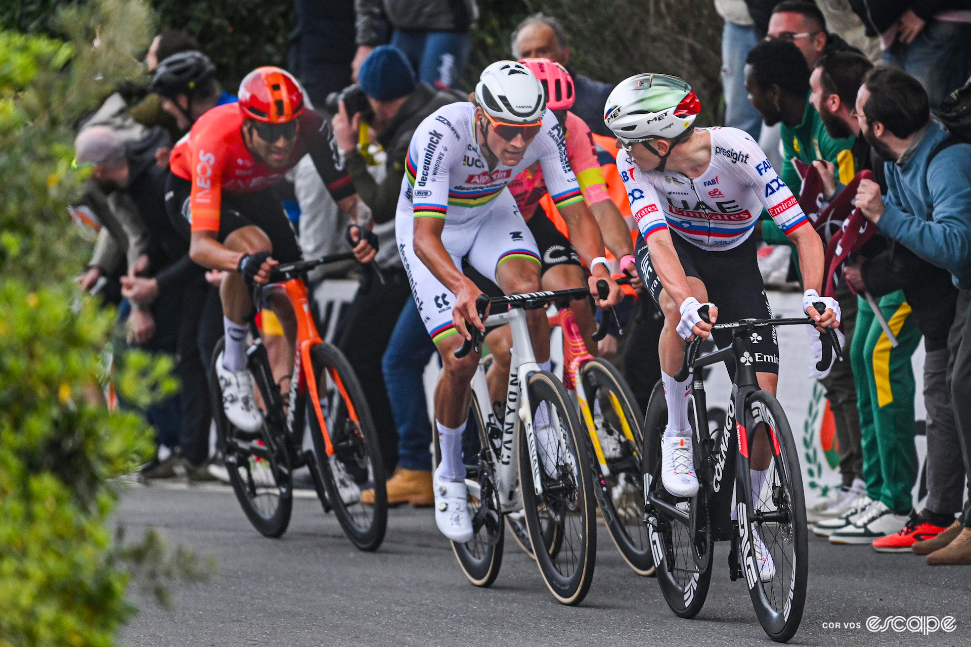 Tadej Pogačar looks over his shoulder to see Mathieu van der Poel and others have joined him after his attack on the Poggio during Milan-San Remo 2024.