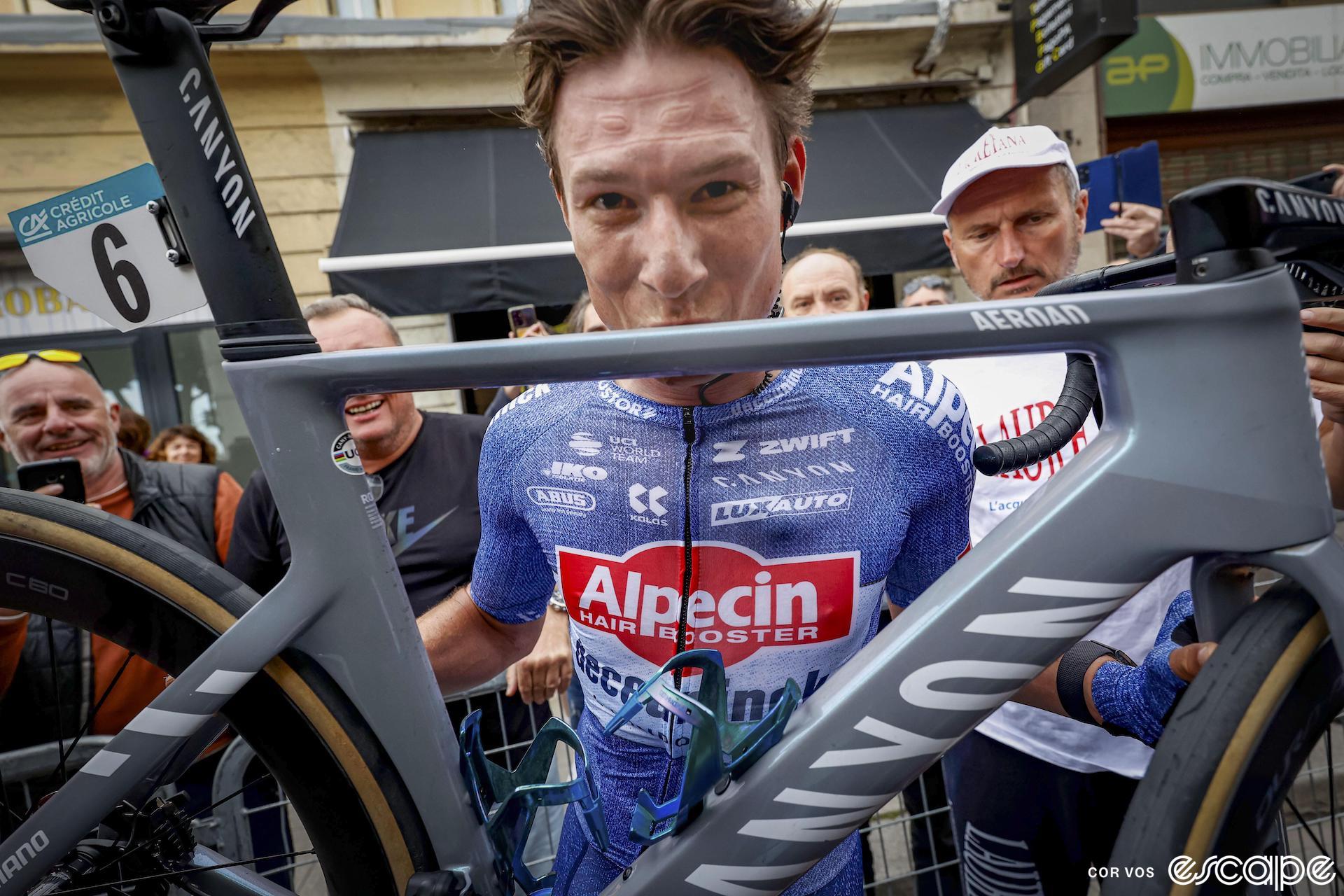 Milan-San Remo winner Jasper Philipsen kisses the top tube of his Canyon Aeroad bike after the win.