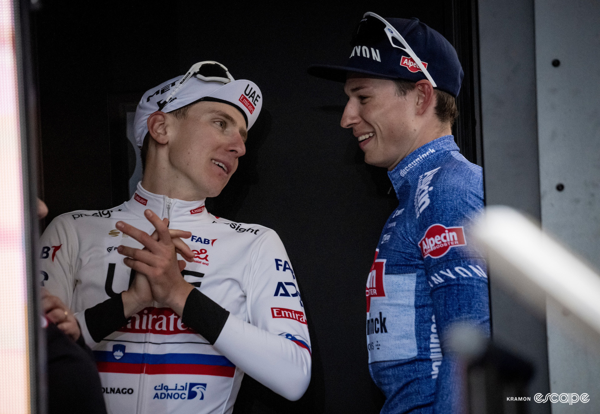Tadej Pogačar and Jasper Philipsen together behind the podium after Milan-San Remo 2024.