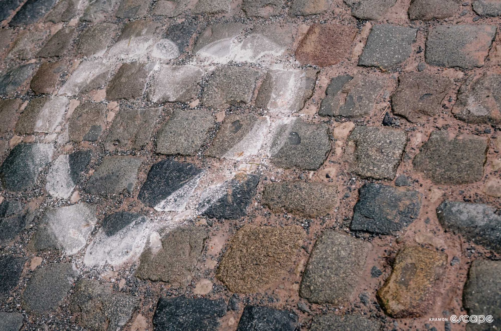 A cobbled road in Flanders with a love heart drawn on it in chalk.