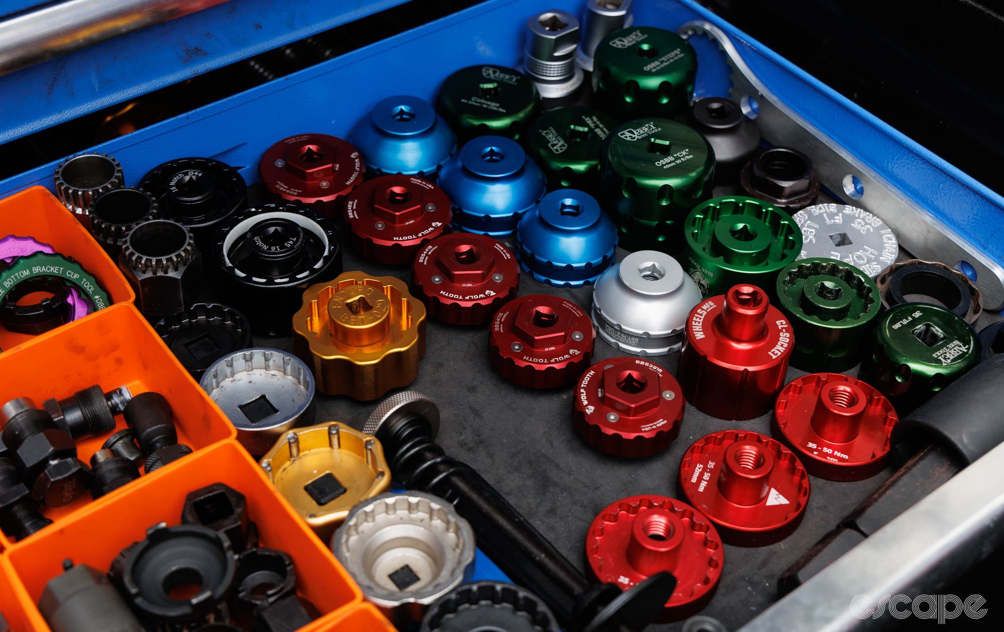 A toolbox drawer full of various bottom bracket sockets from numerous brands. 