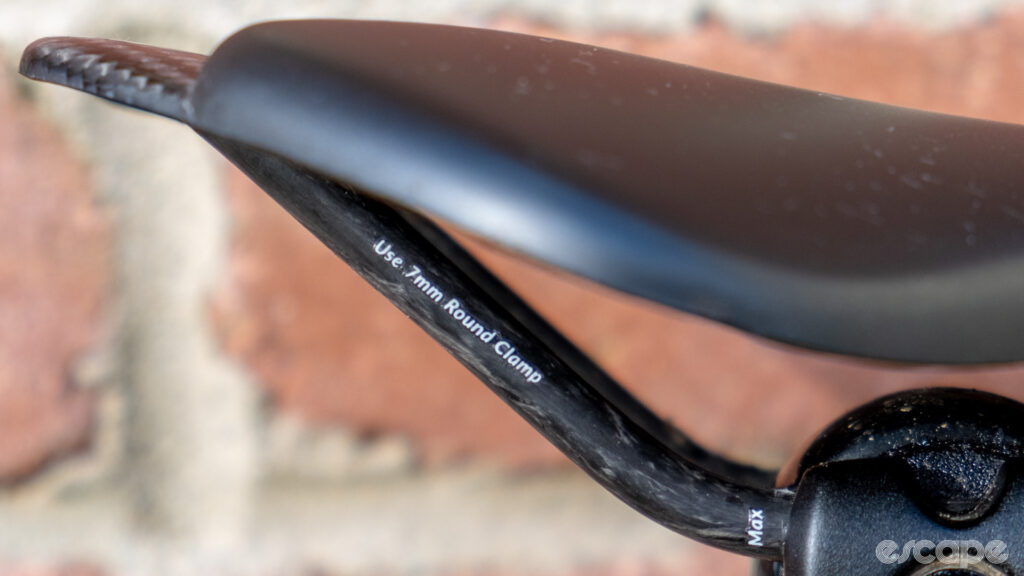 The image shows the carbon rails on a Wove Mags carbon fibre bike saddle.