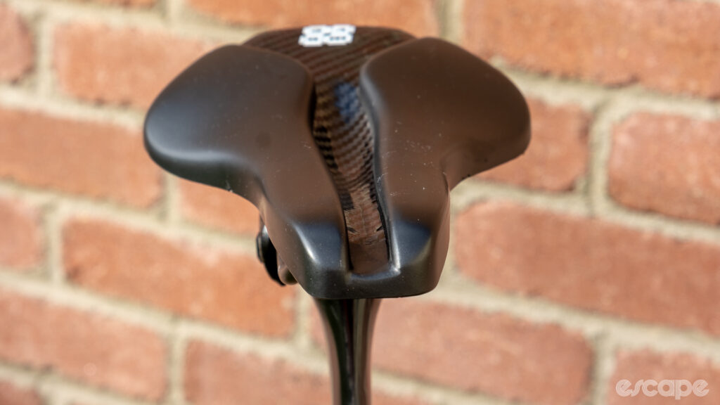 The image shows a head-on view of the Wove Mags carbon fibre bike saddle.