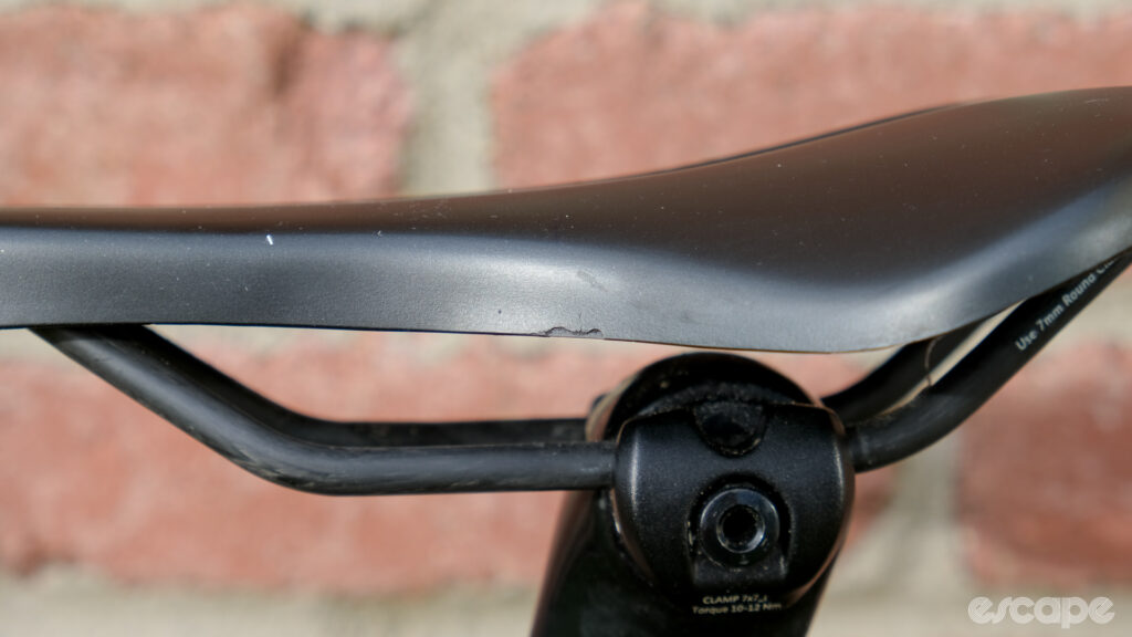 The image shows some signs of wear on a Wove Mags carbon fibre bike saddle.
