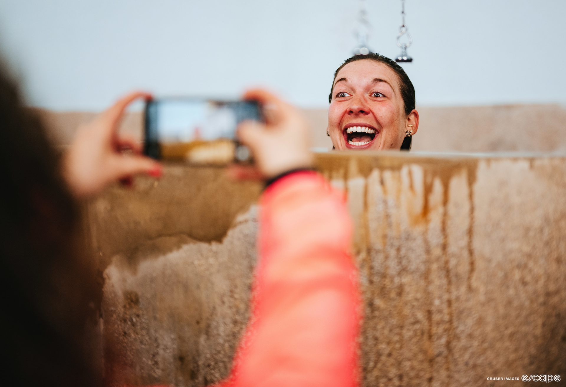 Alison Jackson smiles in the Roubaix velodrome showers. Her head peeks over the concrete walls as someone snaps a cellphone photo.