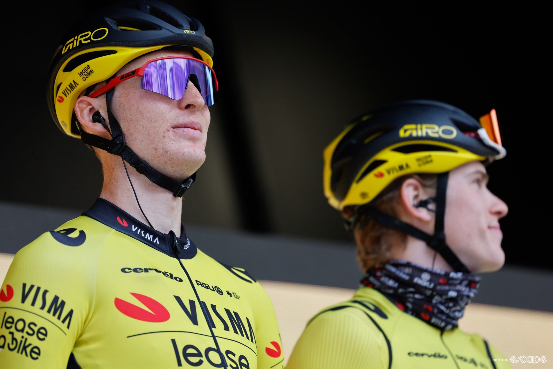 Matteo Jorgenson attends sign in at the 2024 Kuurne-Brussel-Kuurne race. He's in the distinctive yellow jersey of Visma-Lease a Bike and has an impassive expression behind sunglasses.