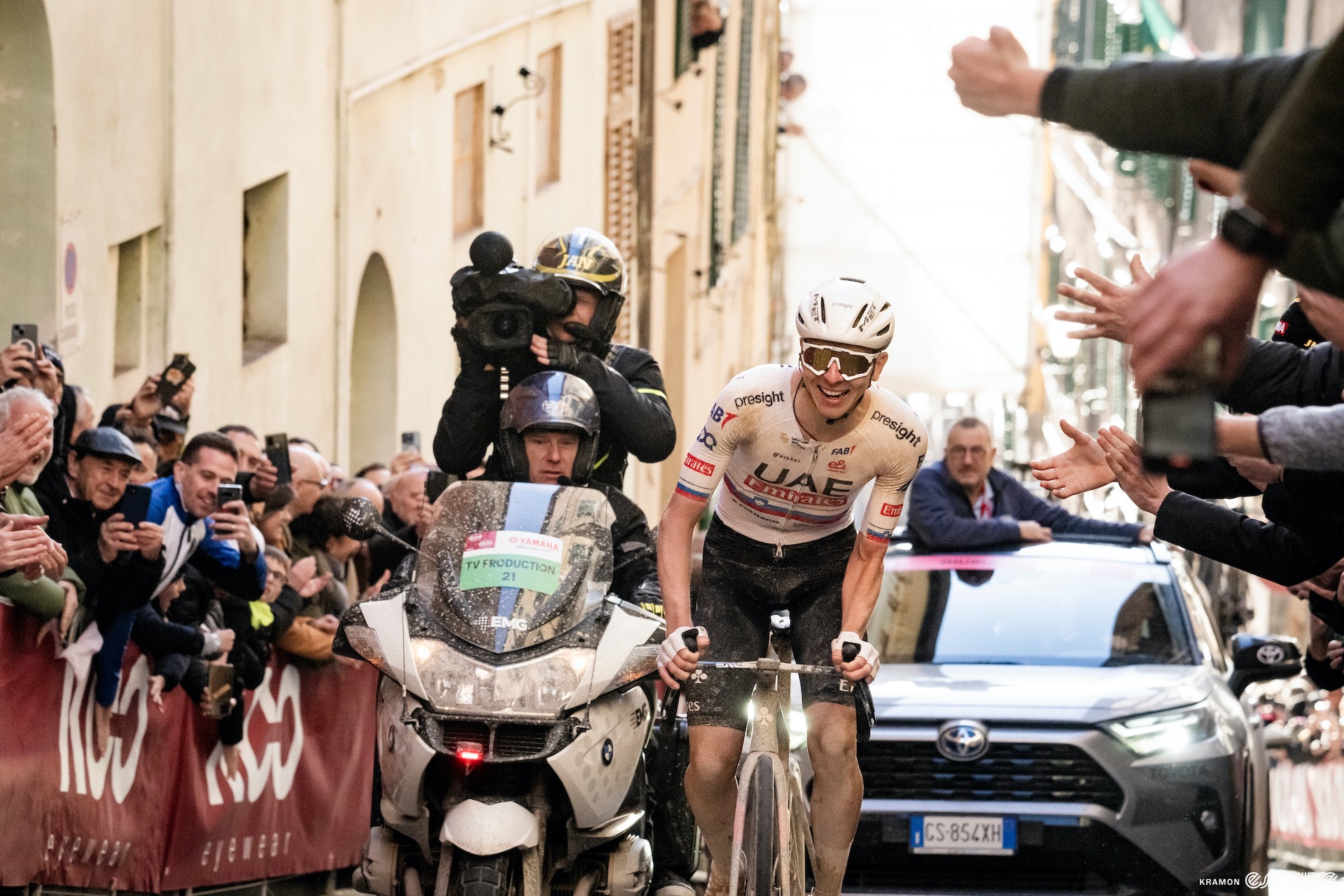 Tadej Pogačar smiles as he climbs the Via Caterina to the Piazza del Campo finish at the 2023 Strade Bianche.