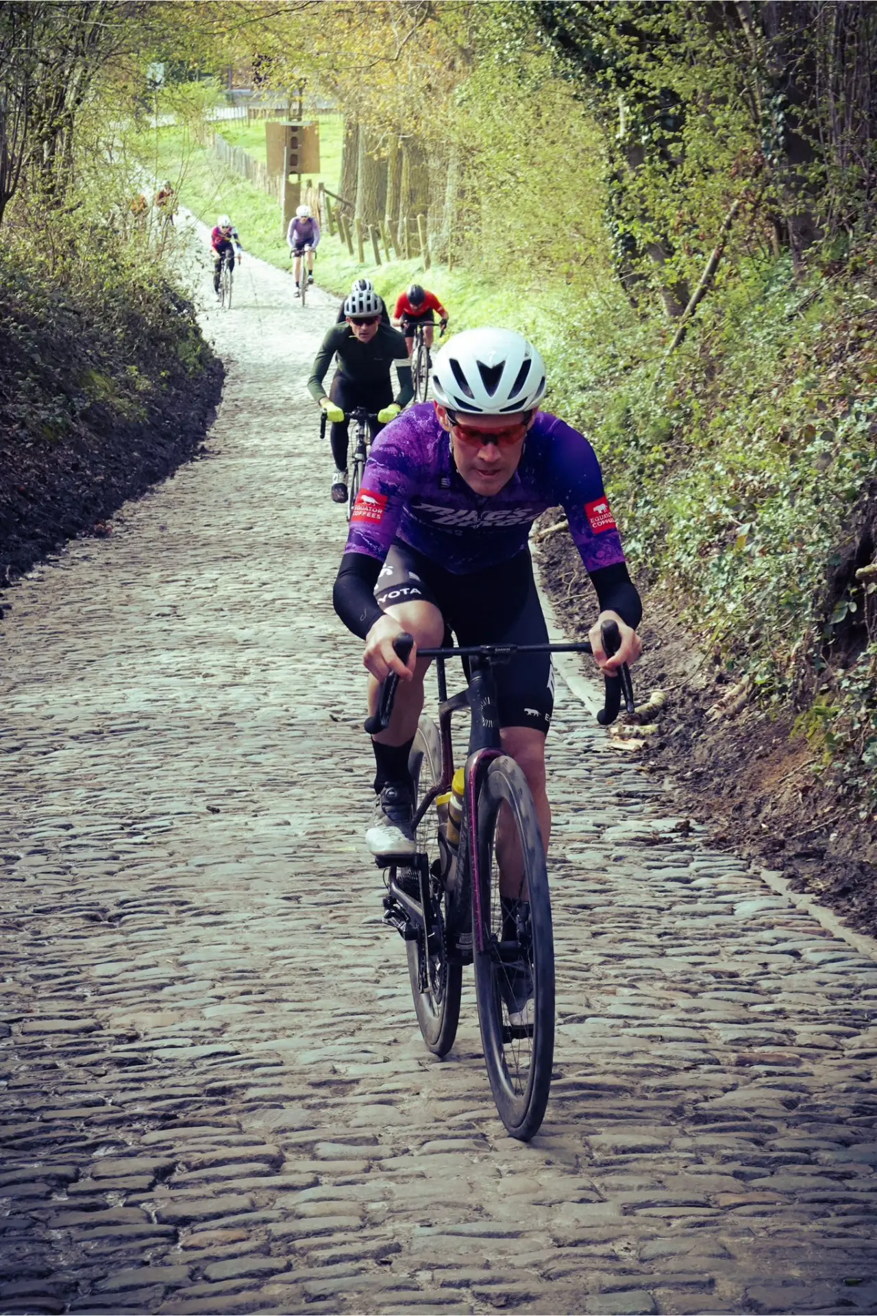 An action photo of Todd Markelz riding up the Koppenberg