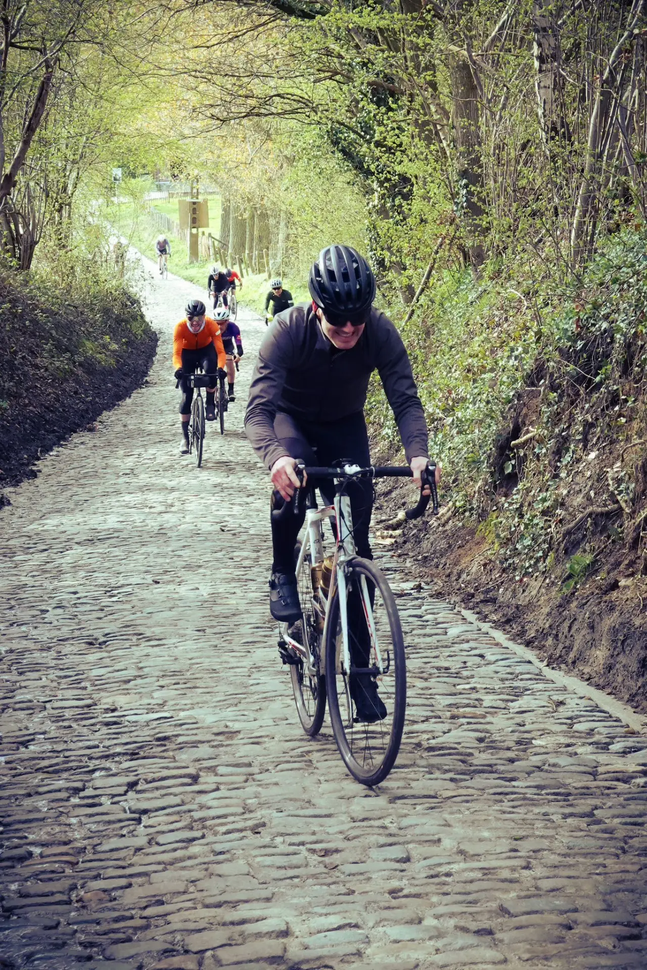 An action photo of a cyclist riding up the Koppenberg