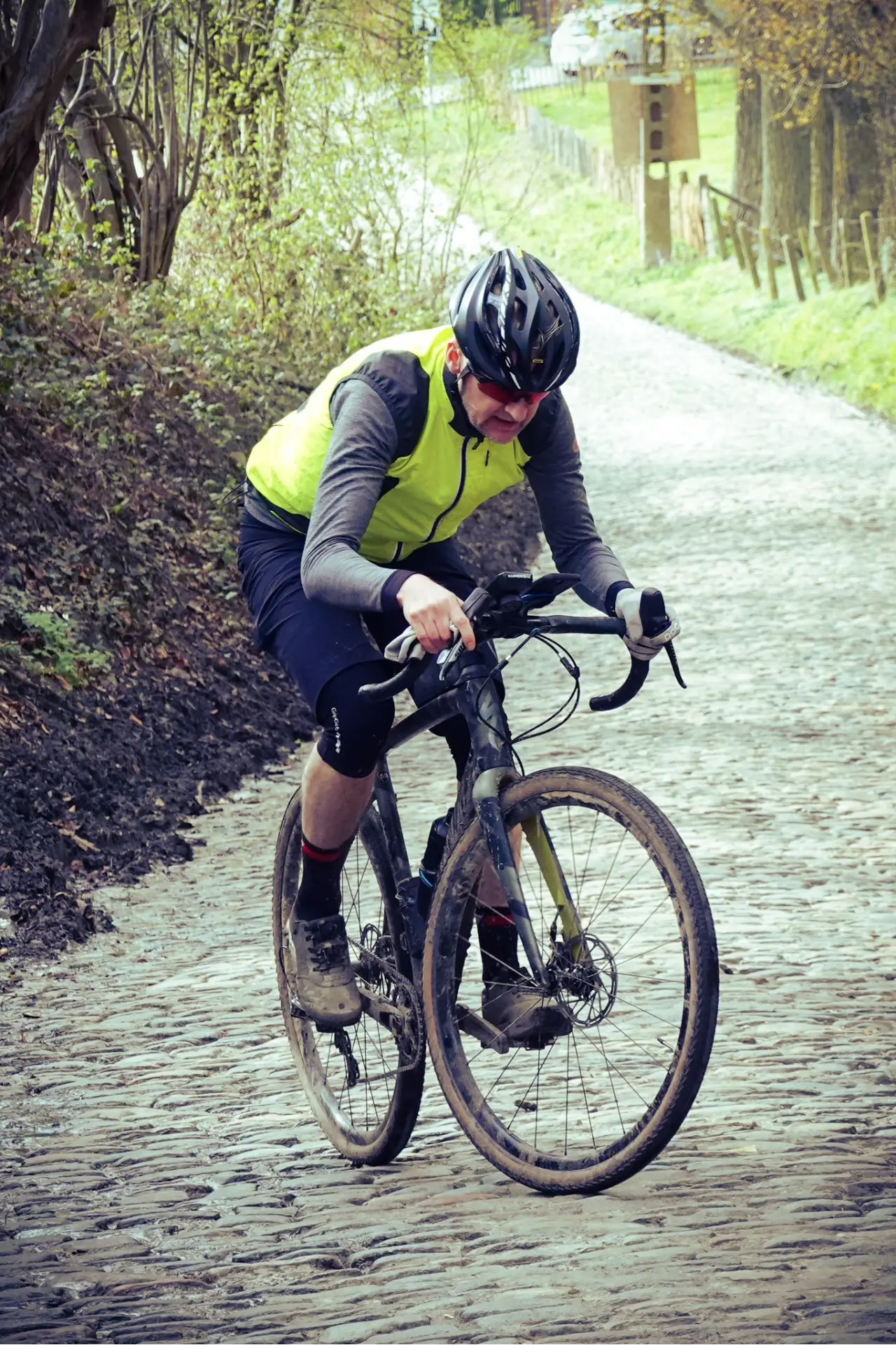 An action photo of John Kennedy riding up the Koppenberg