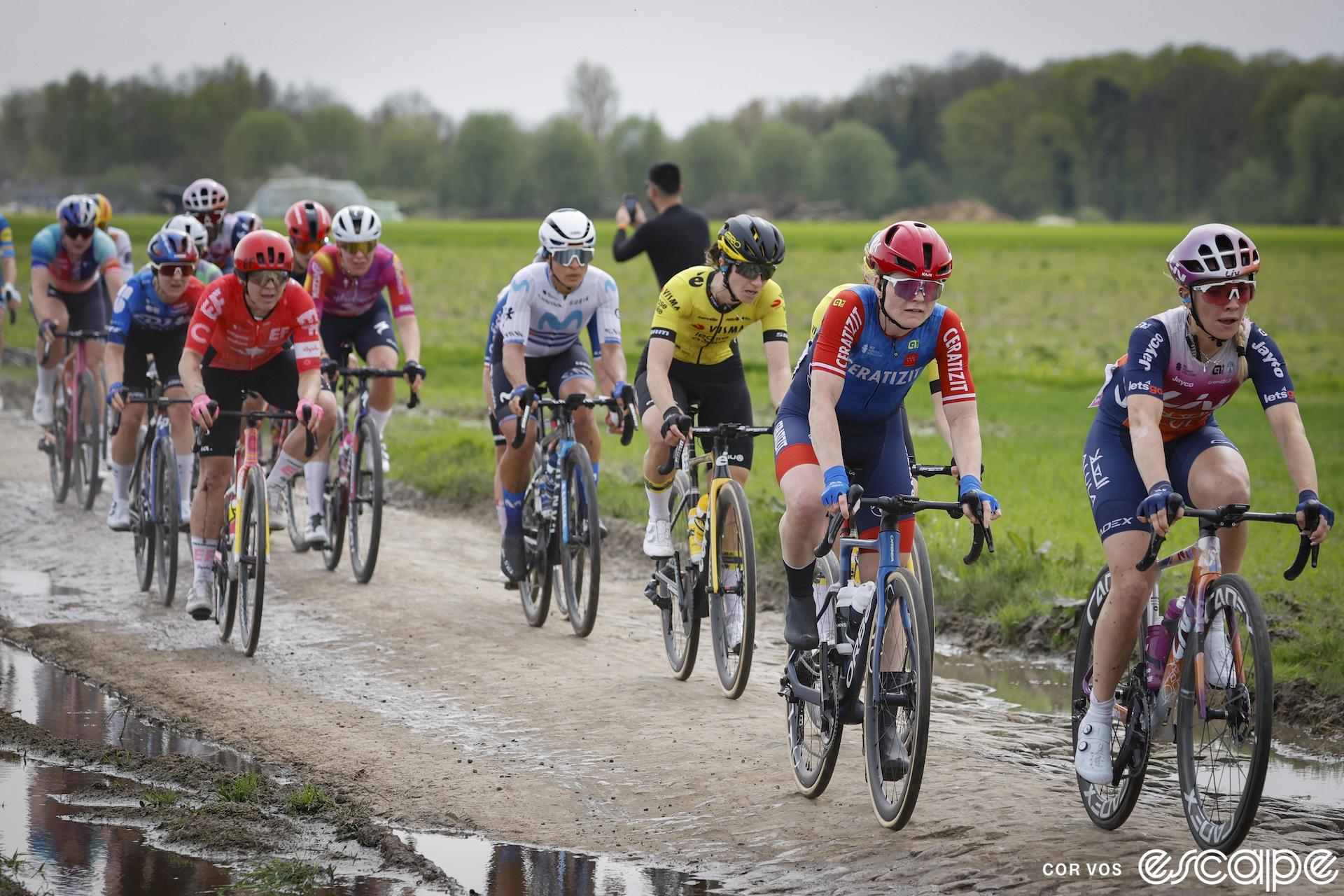 Alison Jackson rides in a group of riders on the cobbles at Paris-Roubaix.