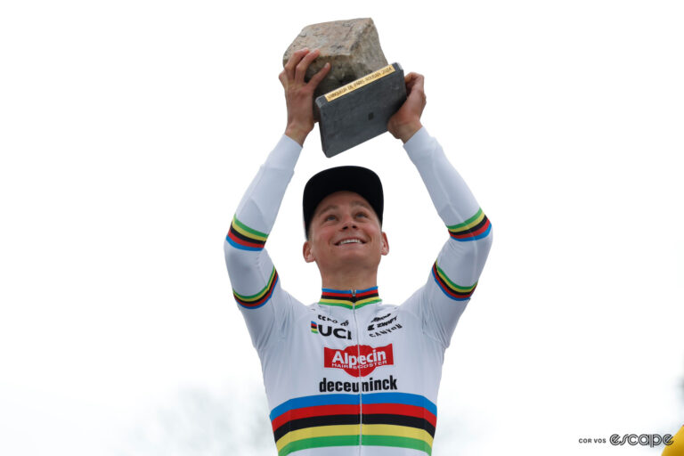 Mathieu van der Poel raises the Paris-Roubaix winner's trophy.
