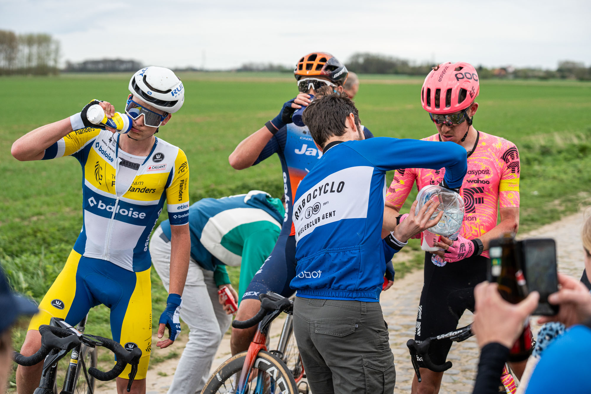 The EF rider and his companions eagerly accept water from roadside fans.