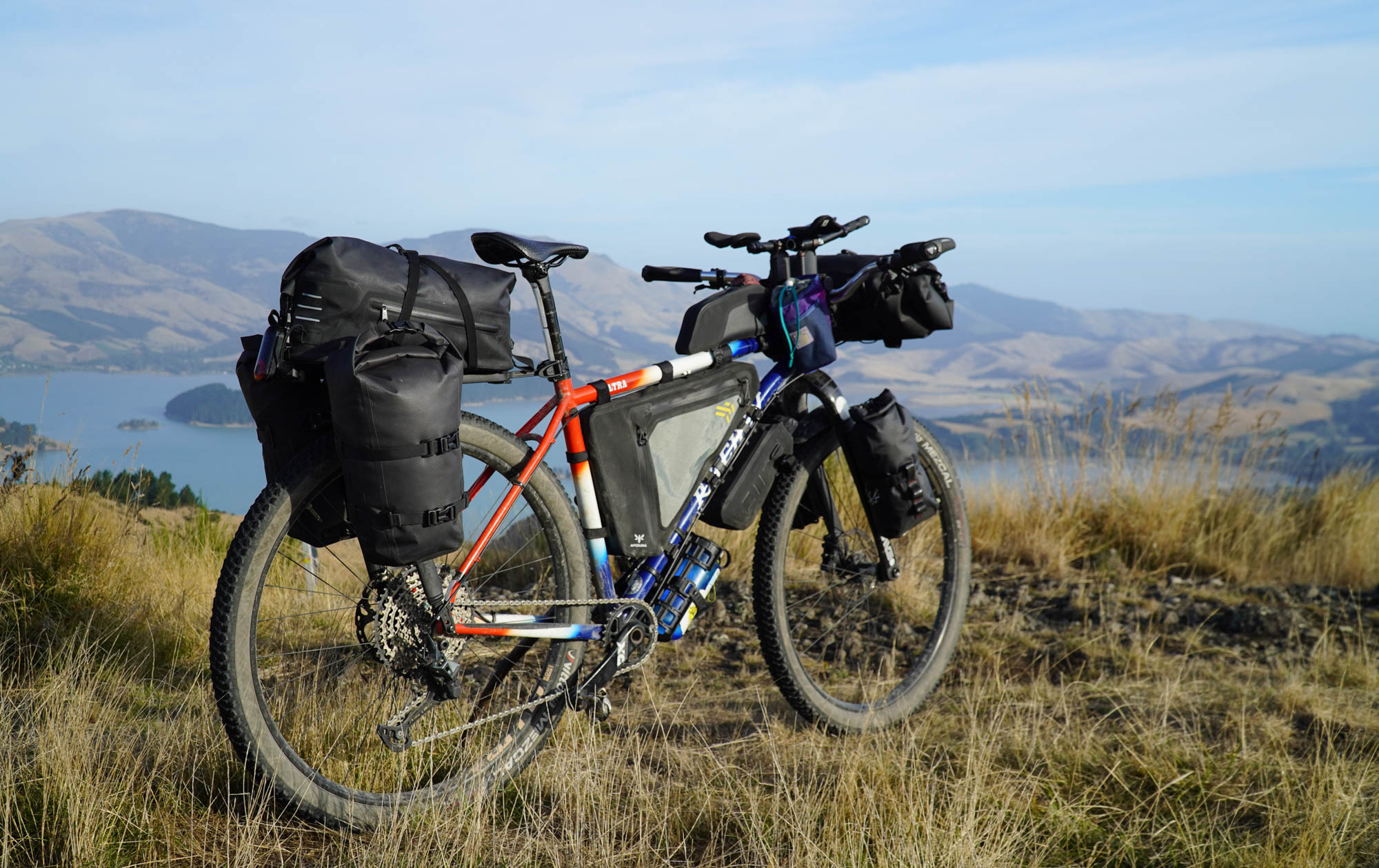 The author's Ritchey mountain bike, fully equipped for loaded bikepacking with a complete complement of frame bags which manage to not quite hide the Ritchey's distinctive red-white-blue fade paint.