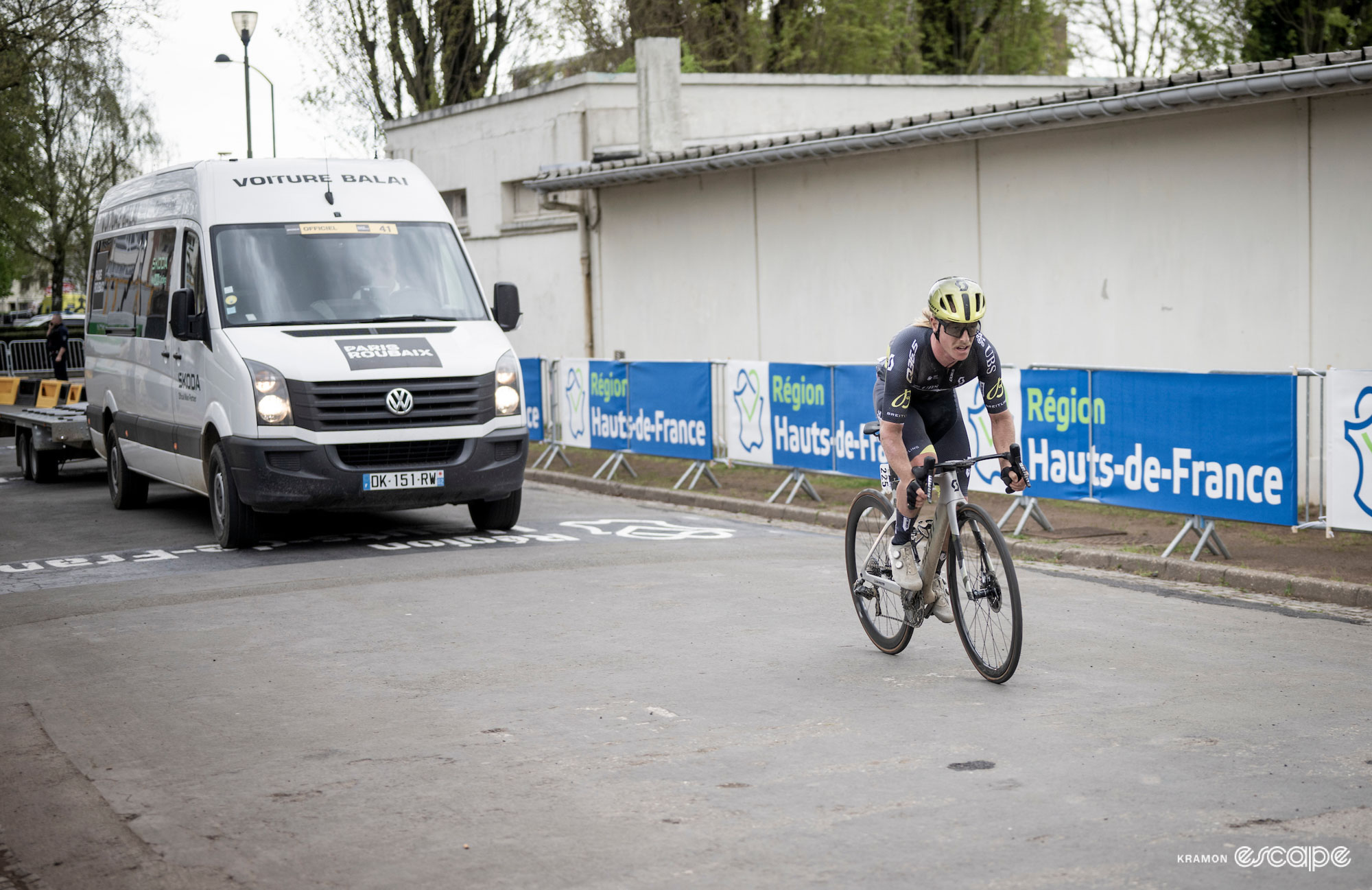Cyrus Monk enters the Roubaix velodrome ahead of the broom wagon. The barriers are empty of fans now.