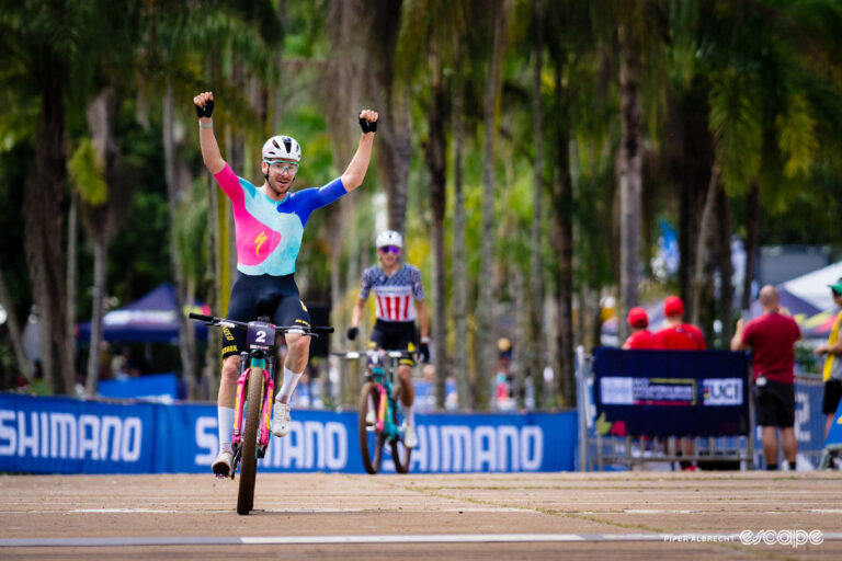 Victor Koretzky raises his arms in celebrations at winning mountain bike World Cup short track in Araxá, Brazil.