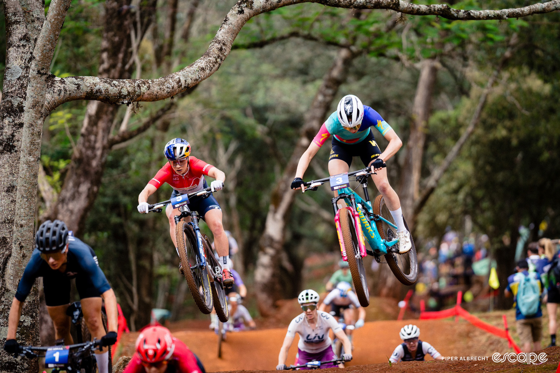 Evie Richards and Haley Batten take a jump during mountain bike World Cup short track in Araxá, Brazil.
