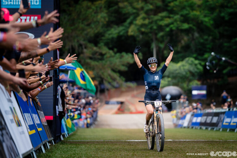Jenny Rissveds raises her arms in victory as she wins the season-opening round of the 2024 Mountain Bike World Cup