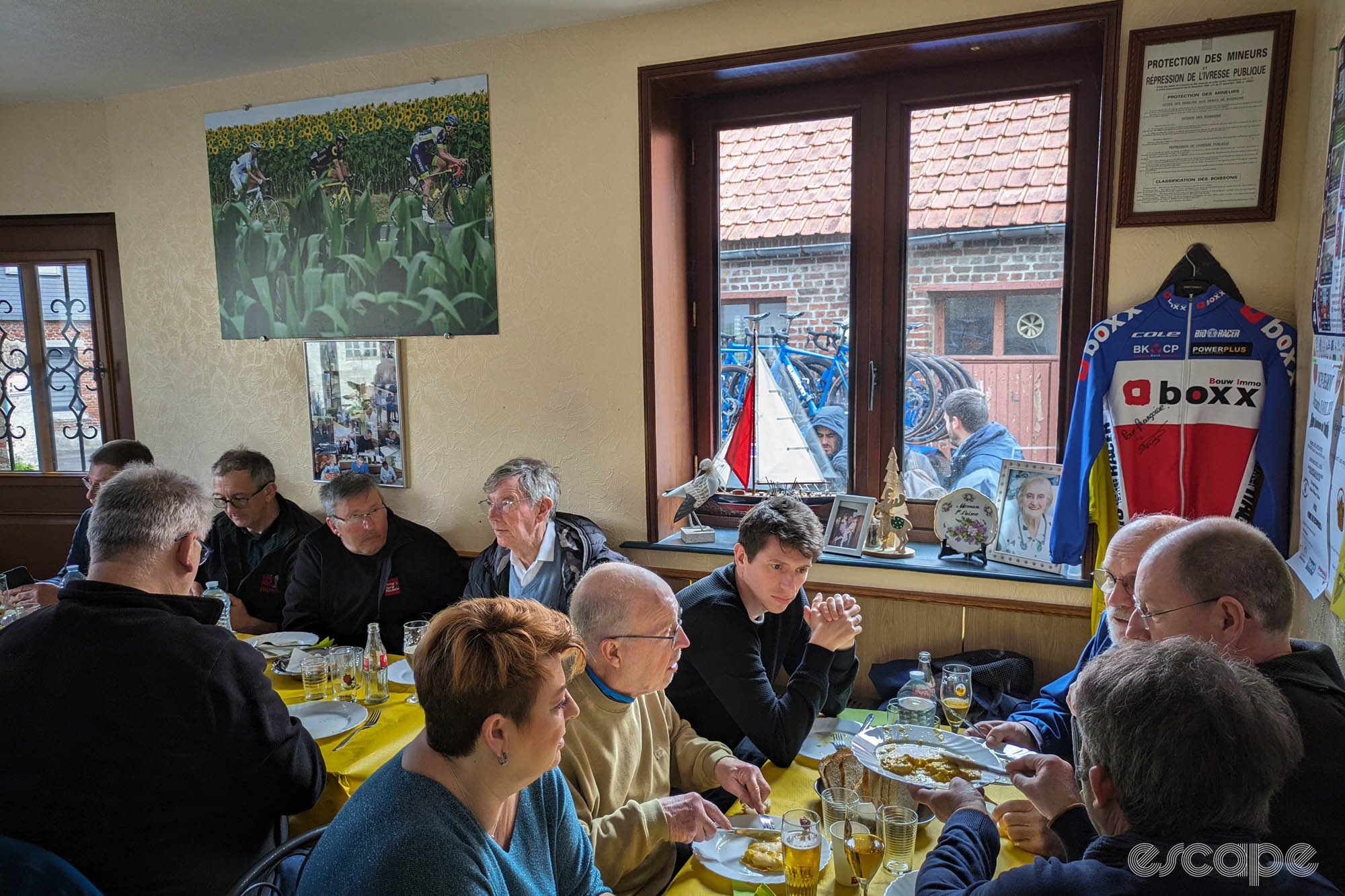 Les Amis de Paris-Roubaix gather at Chez Francoise for omelettes before a course recon. It's a classically French restaurant with bright yellow tablecloths, cycling paraphernalia, and French people of mostly middle and late-middle age gathered at tables.