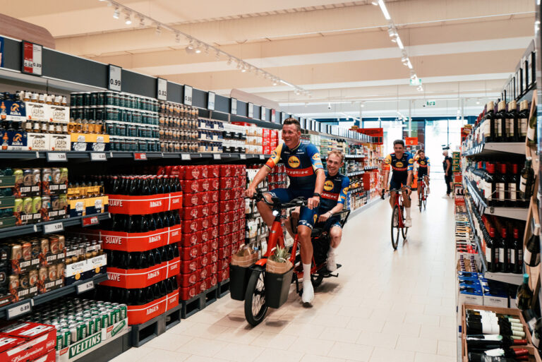 Mads Pedersen rides through an aisle in a Lidl supermarket.