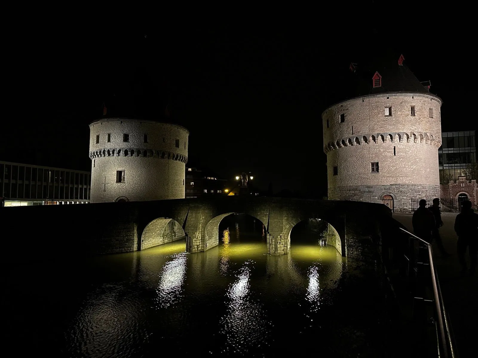 Two towers on either side of an arched bridge. 