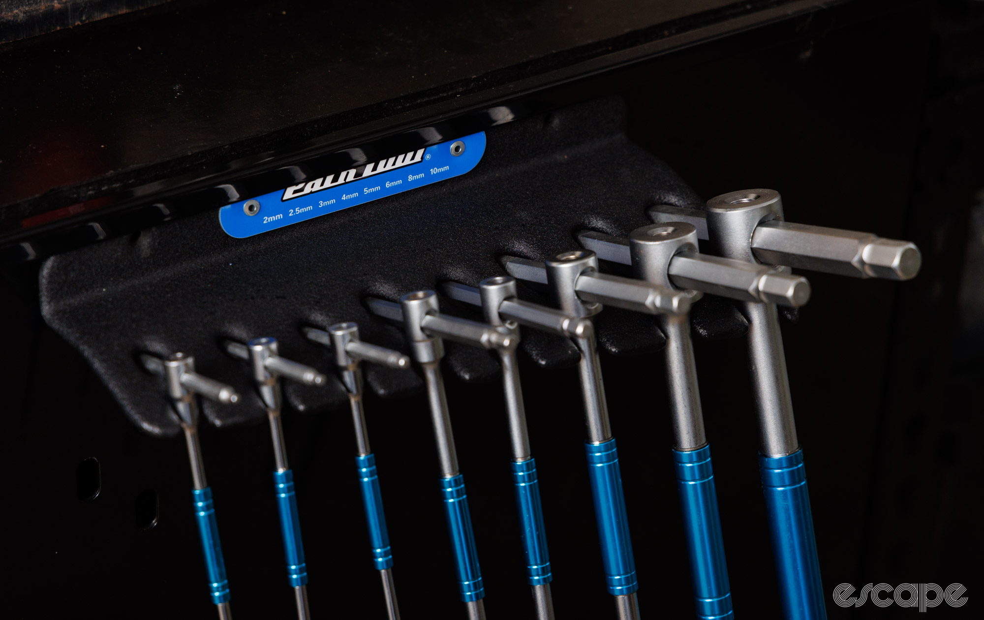A close up of the Park Tool T-Handle Hex wrench holder. It holds the tools by the T-part, with a semi-open design. 
